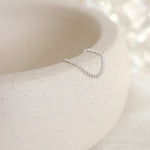 Silver ring on a textured white surface