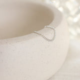 Silver ring on a textured white surface