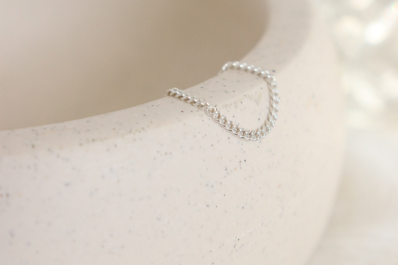 Silver ring on a textured white surface